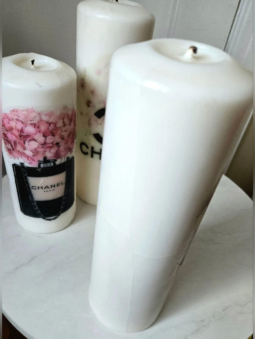 White Pillar Candles with Pink Floral Motif and Black Logo